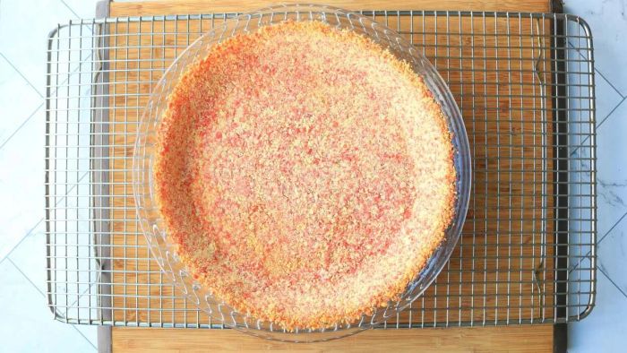 A pie crust resting on a cooling rack.
