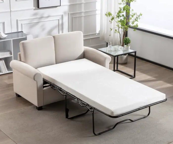 A sofa with a pull-out bed extended in a living room setting