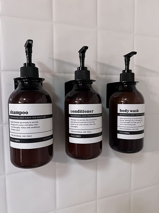 A reviewer’s photo showing the bottles mounted on their shower wall