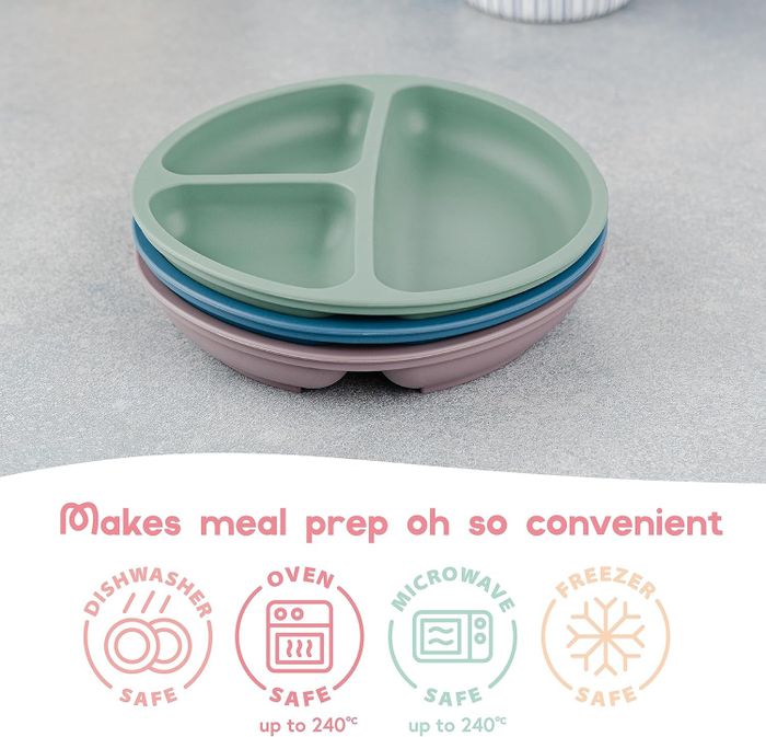 A stack of divided silicone plates, with labels highlighting that they are safe for use in the dishwasher, oven, microwave, and freezer.