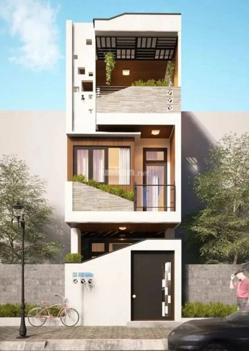 Mẫu nhà ống 3 tầng thiết kế hiện đại, kết hợp với gỗ tạo nên vẻ đẹp sang trọng và tinh tế.
