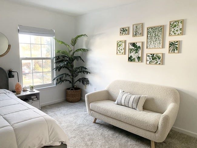 A reviewer’s bedroom showcasing the framed prints hung above a compact sofa