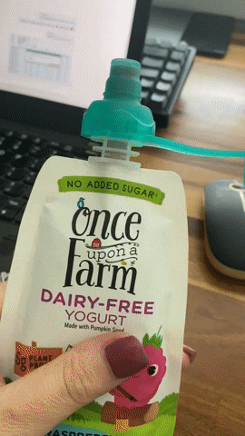 A gif showing someone trying to squeeze a food pouch, but nothing comes out.