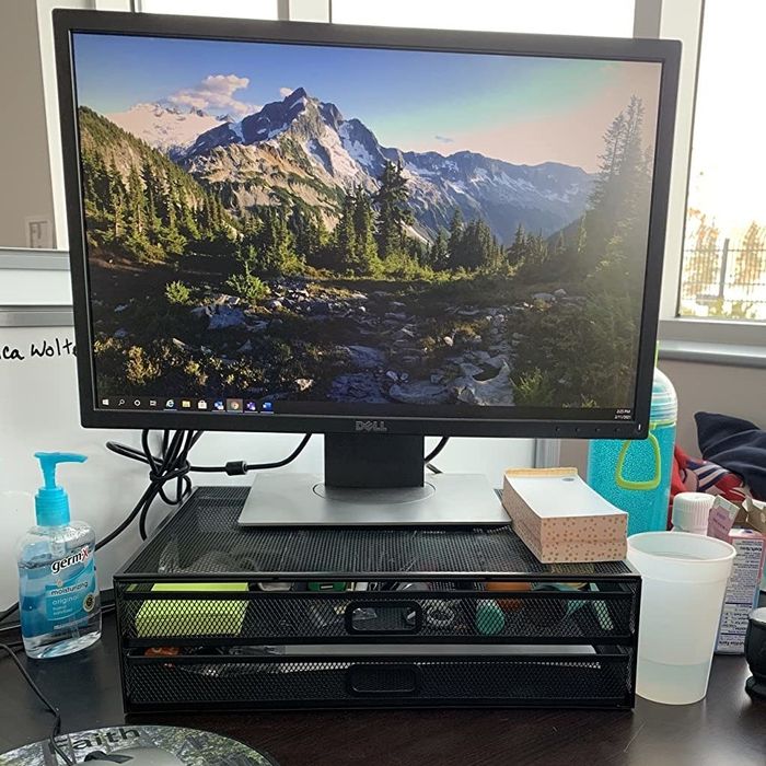 Reviewer image of a sleek black monitor stand