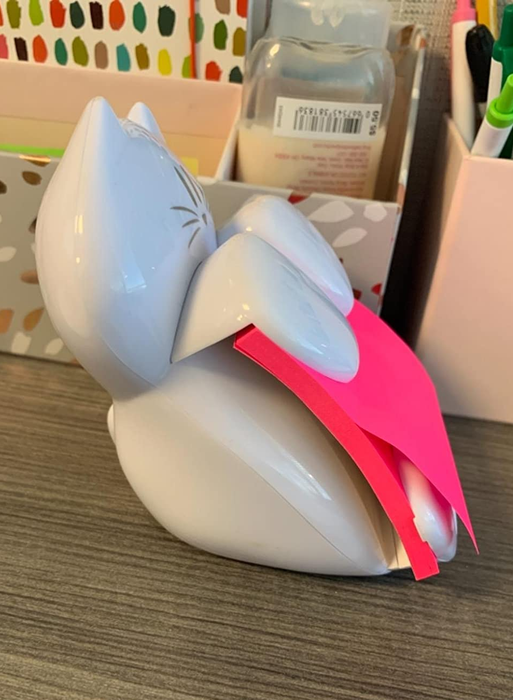 A side view of the cat sticky note dispenser, showing how notes are always ready to be pulled