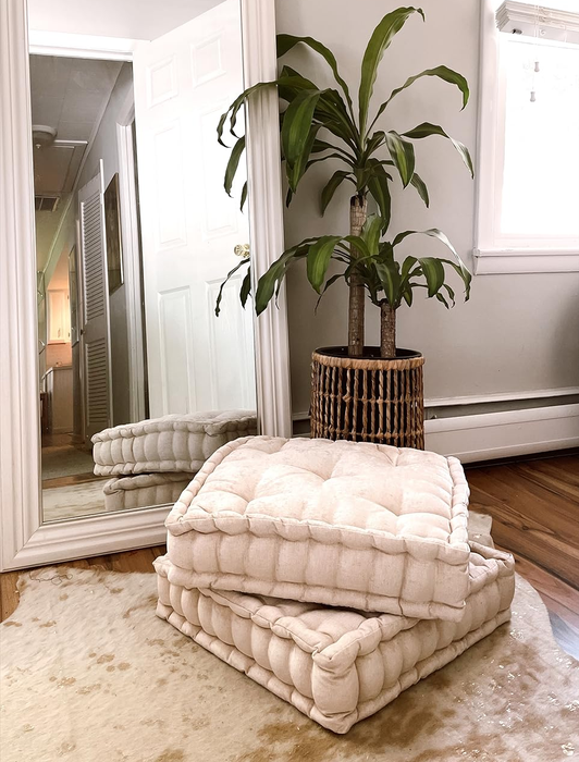 a reviewer’s photo showing two ivory pillows placed beside a full-length mirror