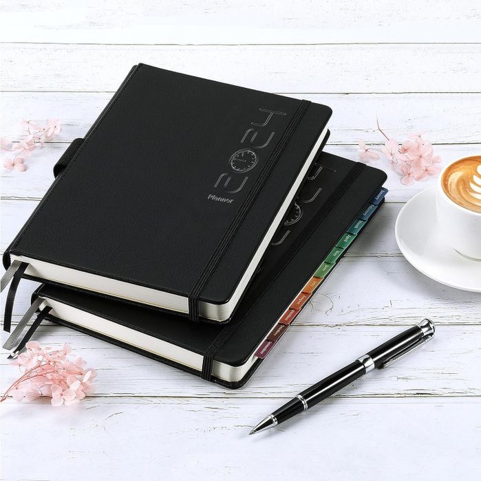 A sleek black planner labeled with "2024"