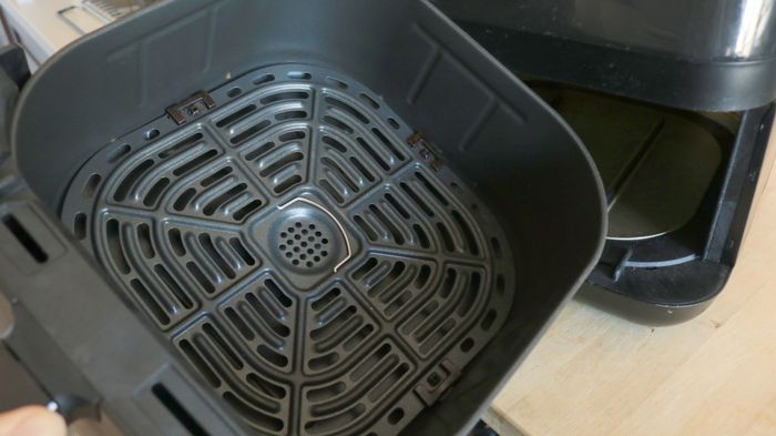 The interior of an air fryer basket.