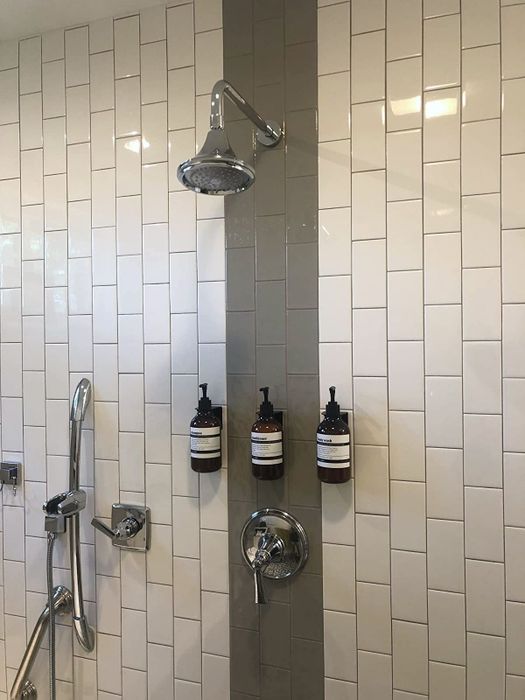 A reviewer’s photo of the bottles installed on their shower wall
