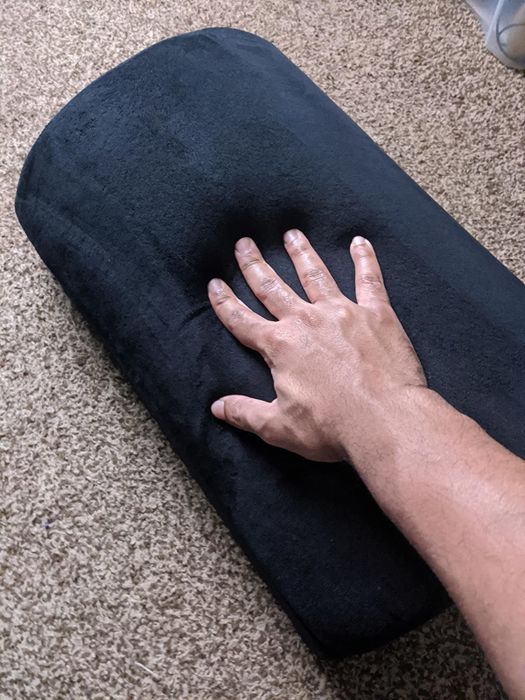 Reviewer photo demonstrating the softness of the footrest by pressing a hand into it