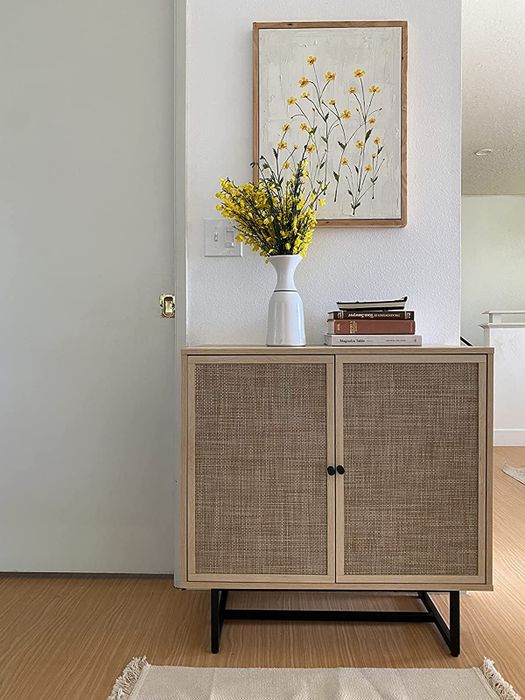 a reviewer’s photo of the light oak rattan storage cabinet
