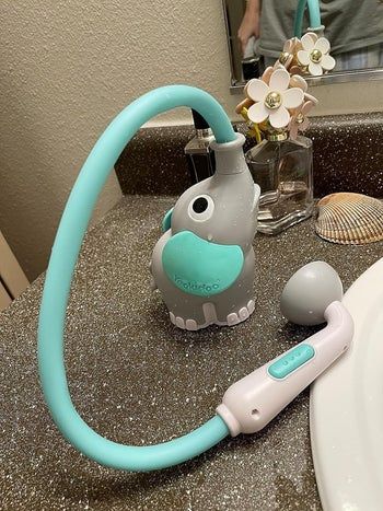 An elephant-shaped hose sprayer for a child's bath