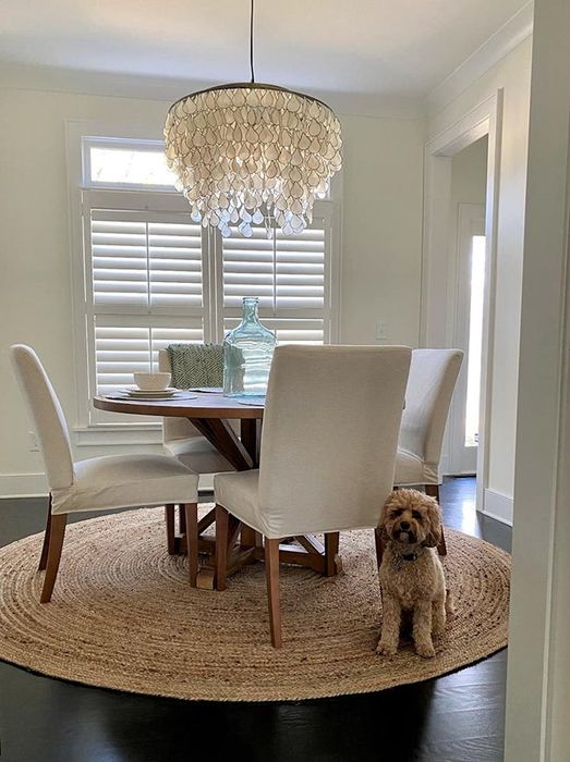 A reviewer’s photo of the circular rug placed in their dining room