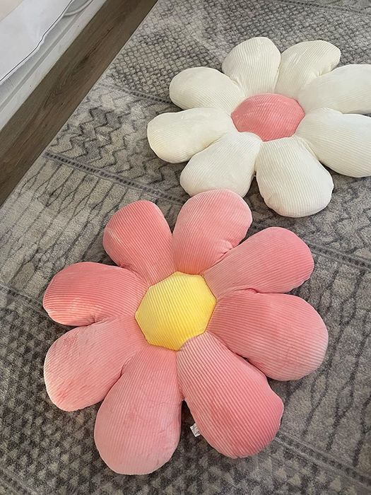 A reviewer’s photo showcasing two decorative flower pillows.