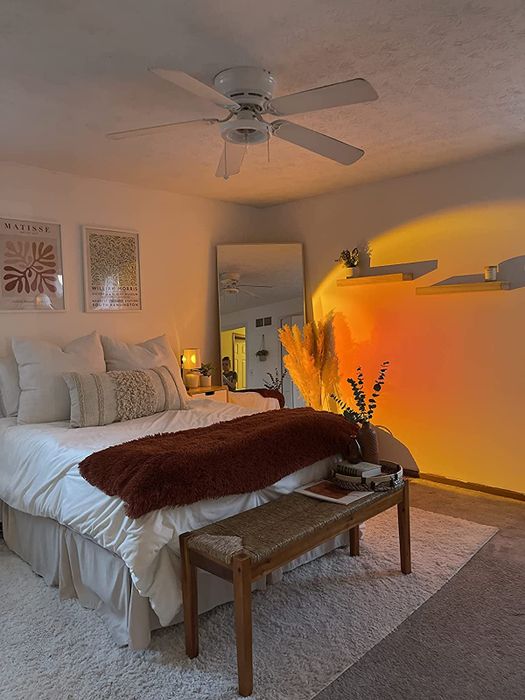A bedroom wall bathed in concentrated orange light, offering a serene and inviting atmosphere.