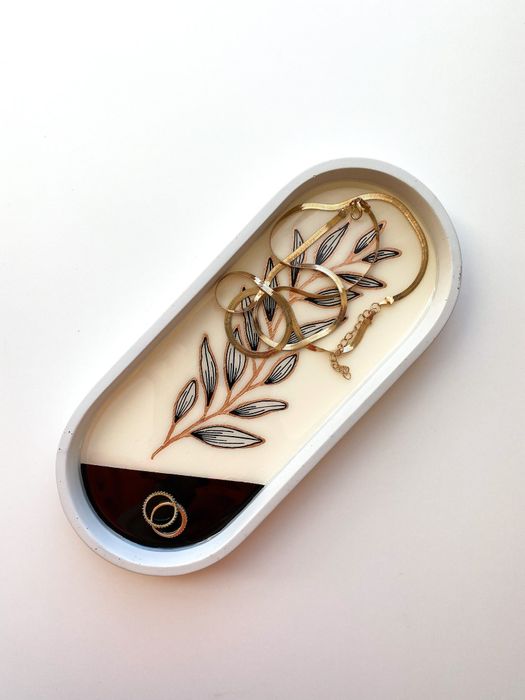 A concrete tray adorned with jewelry.