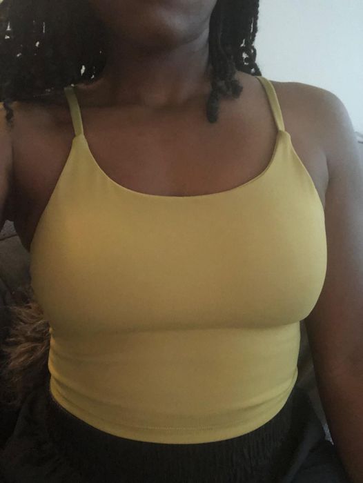 reviewer showcasing the yellow tank top