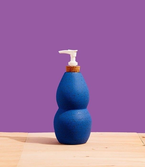 A uniquely designed blue soap dispenser