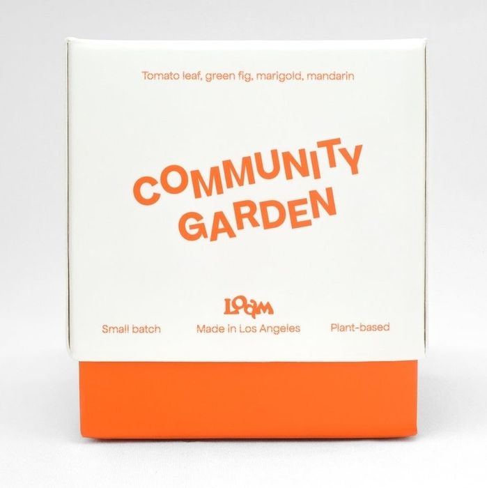 Candle packaging labeled Community Garden