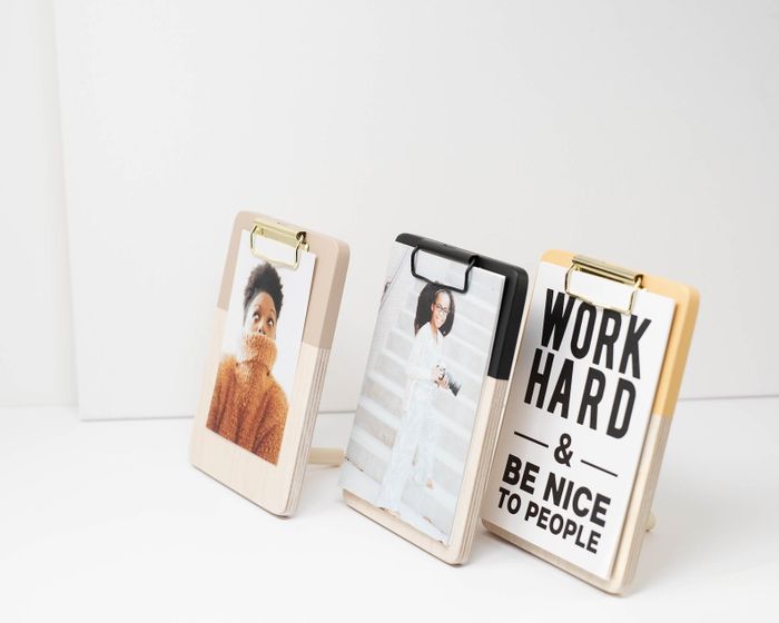 Three clipboards displaying inspirational quotes and photos