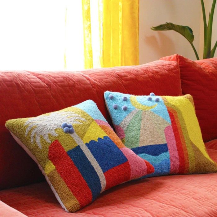 Two decorative pillows are displayed