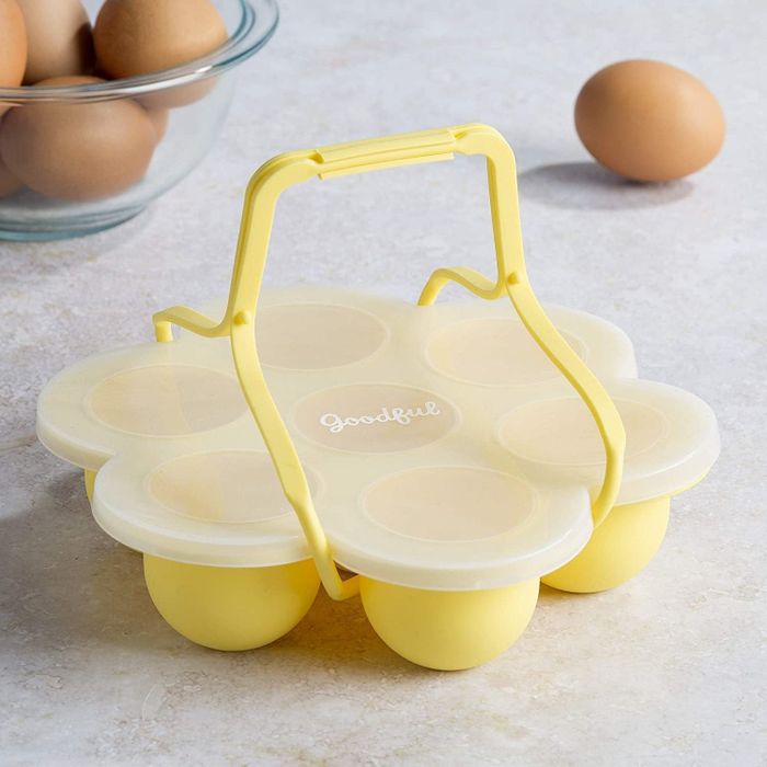 A seven-egg cooking mold, complete with a handy handle and lid.