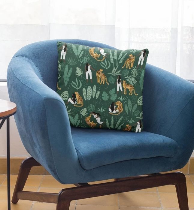 A throw pillow adorned with a design of a person, plants, and a cheetah