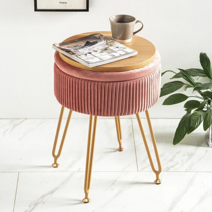 The storage ottoman topped with a mug and magazine, ready for relaxation.