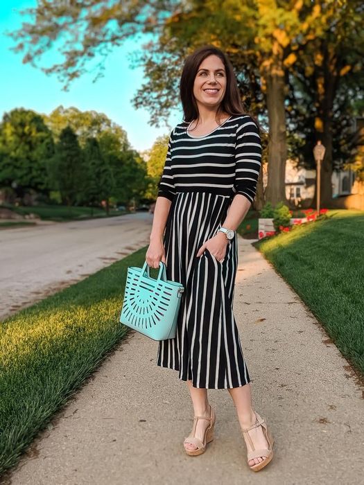 reviewer modeling the black dress with white stripes