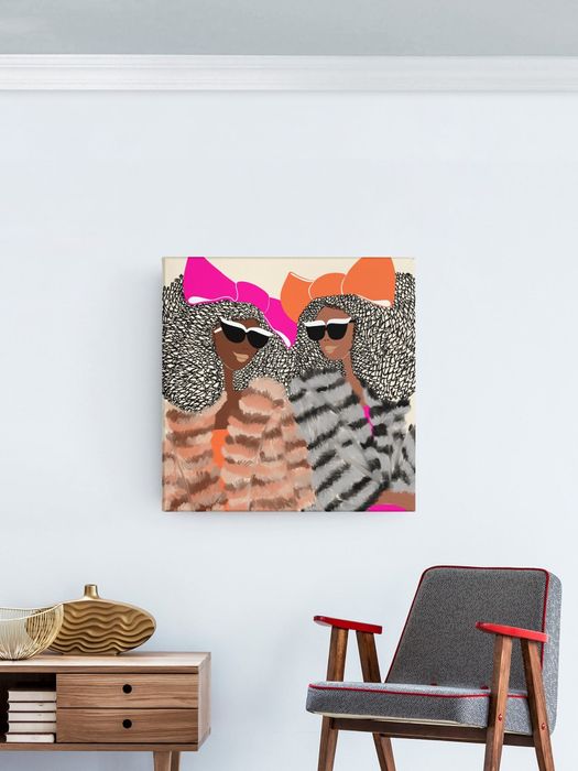 A piece of artwork featuring two stylized figures wearing sunglasses and headscarves, displayed on a wall above a contemporary interior setting.