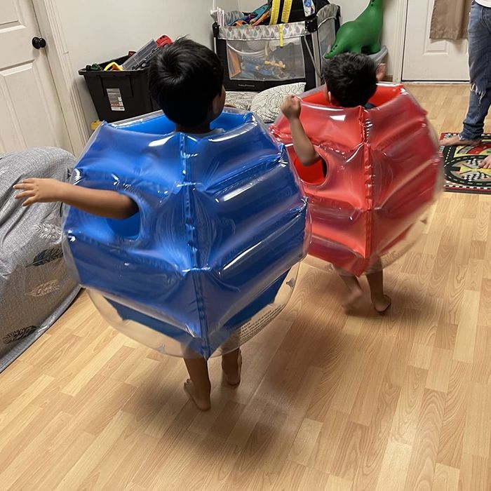 A reviewer's kids wearing the inflatable body bumpers