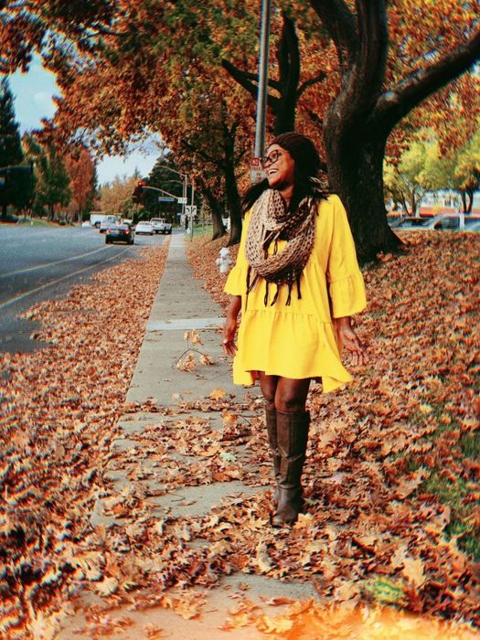 A reviewer showcasing the yellow dress paired with a scarf