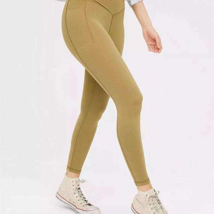 model sporting the olive moss leggings paired with Converse high-top sneakers