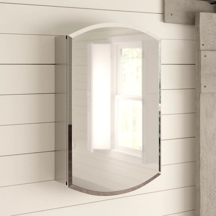 The frameless mirrored cabinet mounted on a bathroom wall.