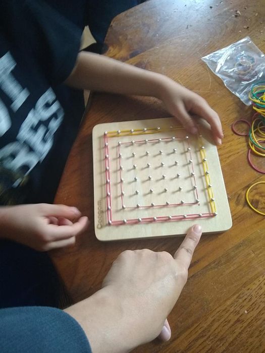 a reviewer's child's vibrant red and yellow design crafted on the geoboard
