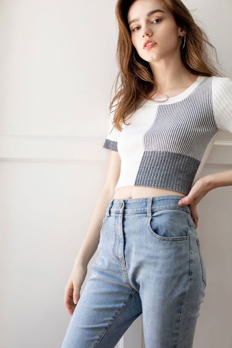 model showcasing the white and grey colorblock top with jeans