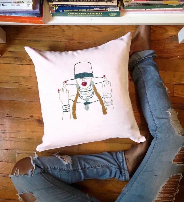 A pillow featuring Beyoncé's face is displayed