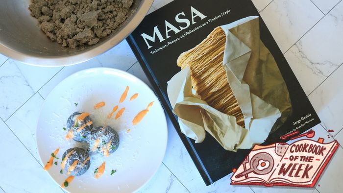 Bollos resting on a plate beside the Masa cookbook.