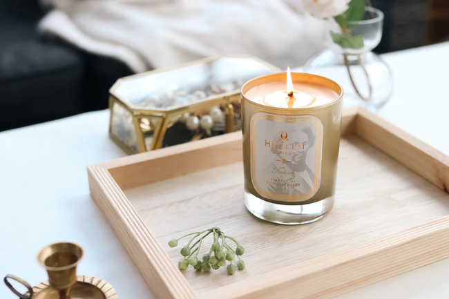 Lit candle resting on a tray
