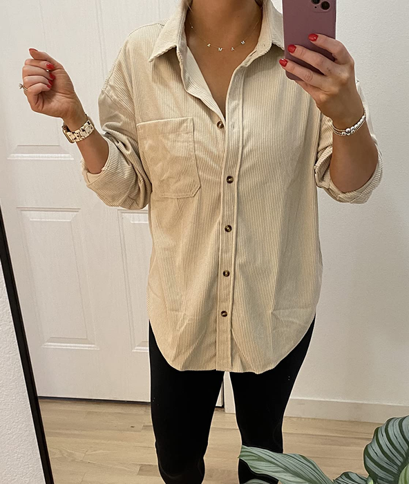 reviewer showcasing the beige shirt worn buttoned up