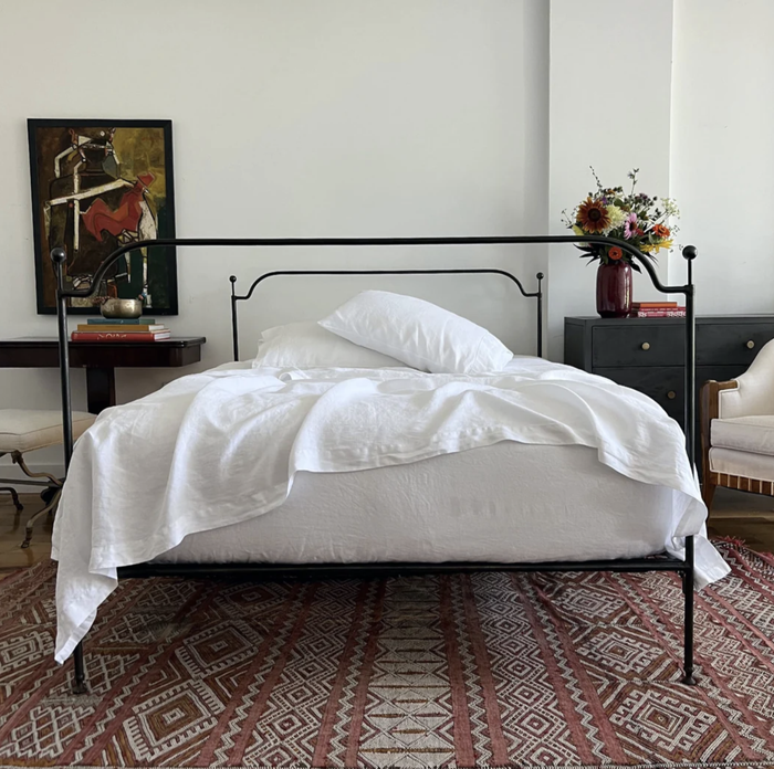 A bed dressed in pristine white linen bedding