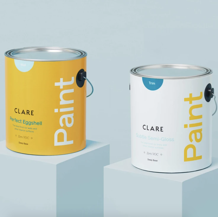 A can of eggshell interior paint and a can of semi-gloss interior paint are showcased on pedestals