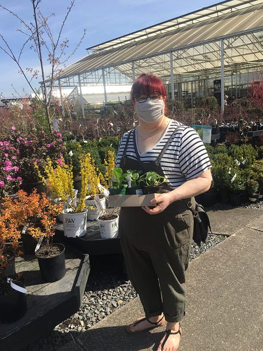 reviewer showcasing the green overalls
