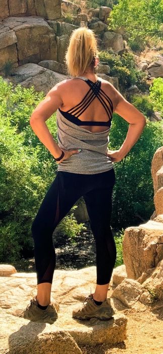 Another reviewer wearing the gray tank, showcasing the strappy bra and low-cut back design
