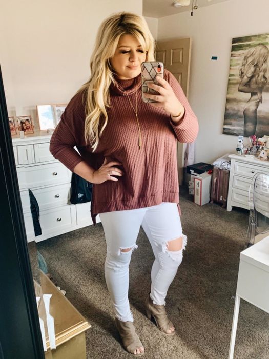 Reviewer showcasing the tan flowy turtleneck