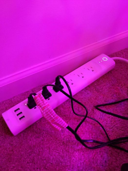 A reviewer's smart plug power strip is displayed, ready for use in managing electrical devices.