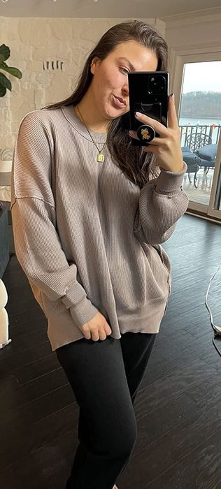 reviewer modeling the brown sweater