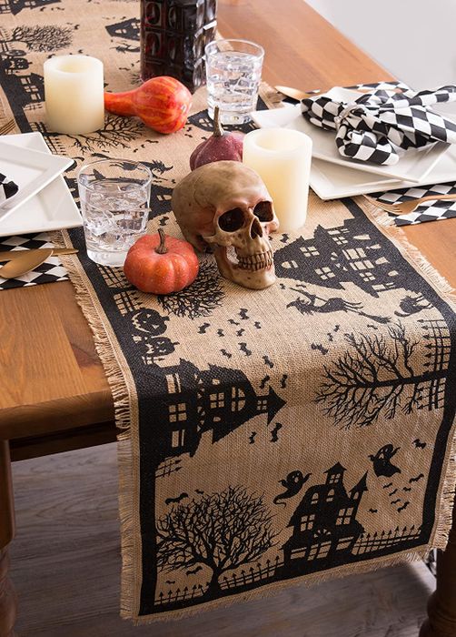 burlap runner featuring a black Halloween-themed pattern, displayed on a decorated table