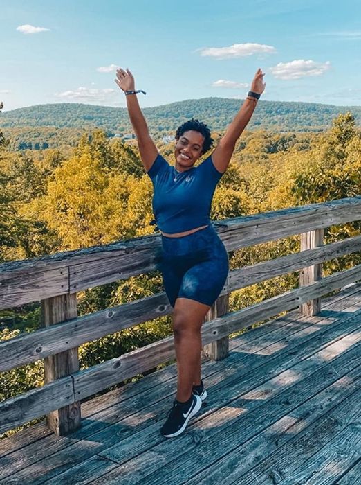 Reviewer wearing the bike shorts in a blue snake print