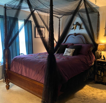 reviewer’s bed with curtains tied to each post